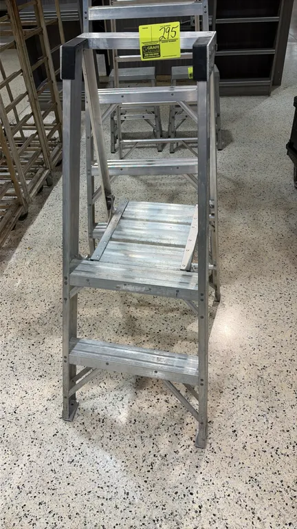Louisville aluminum platform step ladder. Features ribbed slip-resistant steps, fold-down standing platform, top grab rail, and folding design for sto