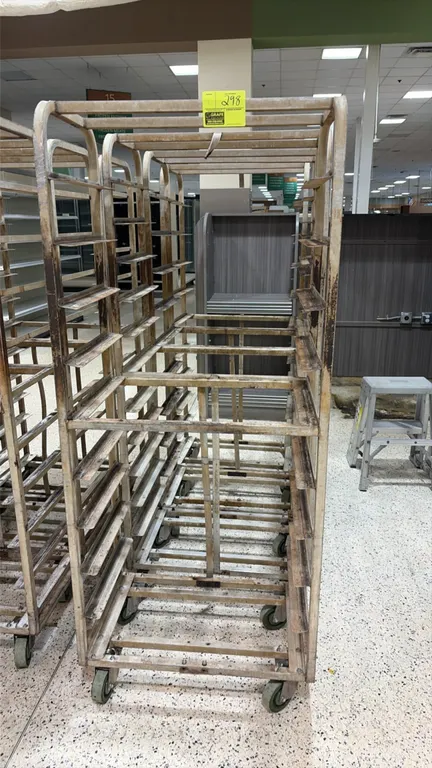 Aluminum side-load oven racks. Features tubular aluminum frame with welded side-loading pan slides. Mounted on swivel casters.