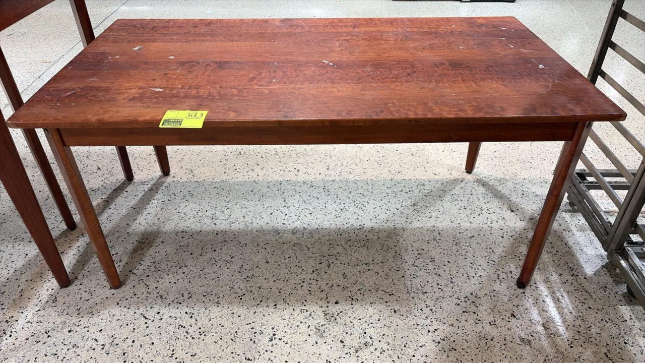 Wood bakery display table. Features wood construction with four tapered legs. Dimensions: 60" x 32".