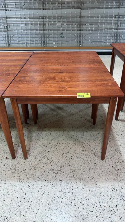 Wood bakery display tables. Features solid wood construction with a warm finish and tapered square legs. 38" x 30" each.