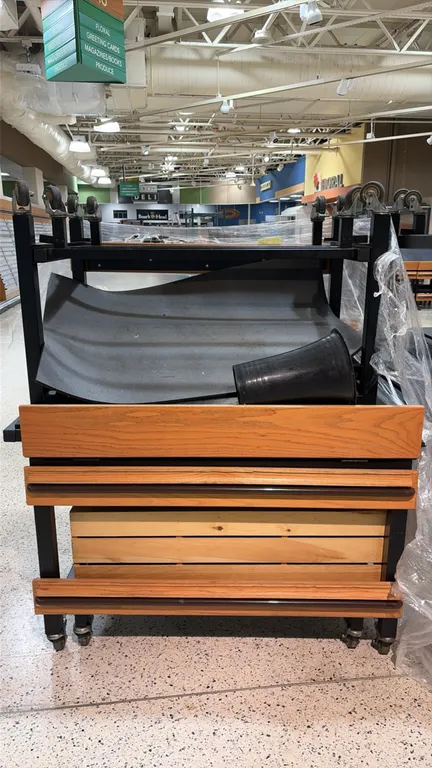 Produce tilt tables. Features black metal frames, wood-look trim with protective bumpers, and adjustable tilt tops. 4'L. Mounted on swivel casters. Co