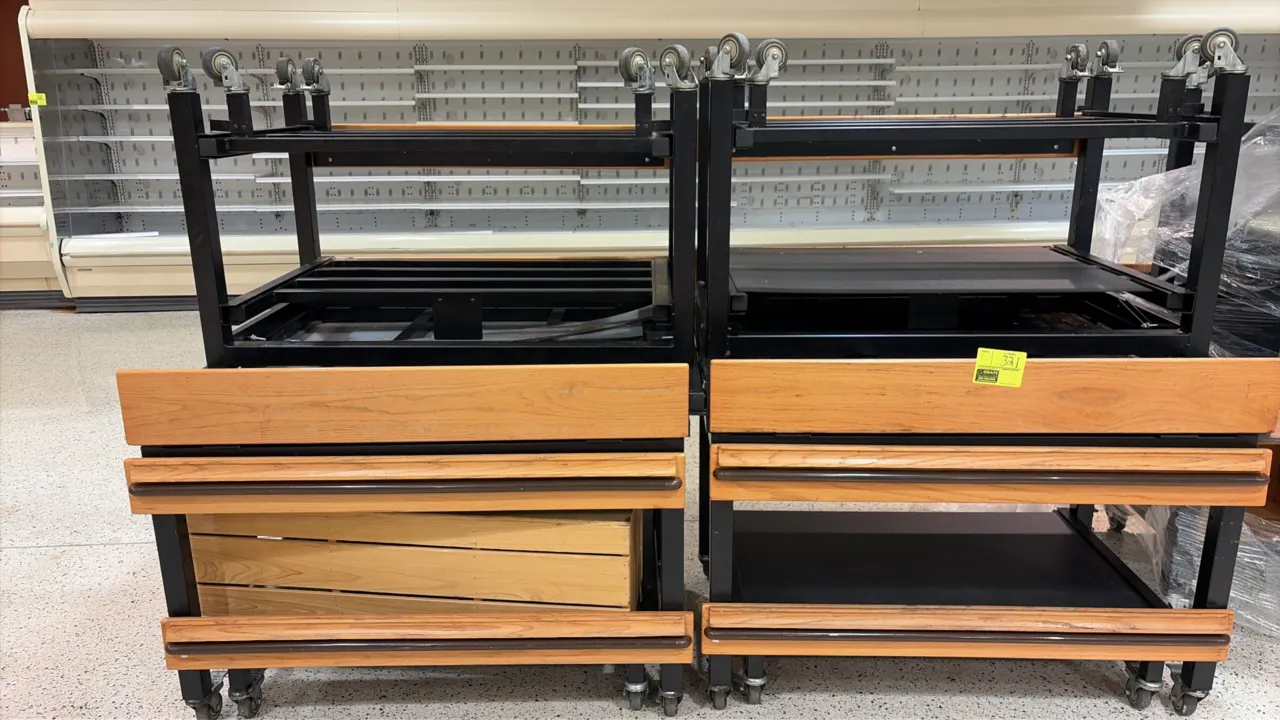 Produce tilt tables. Features wood-look trim with bumper rails, adjustable tilt display surface, lower storage shelf, and black metal frame. 4'L. Moun