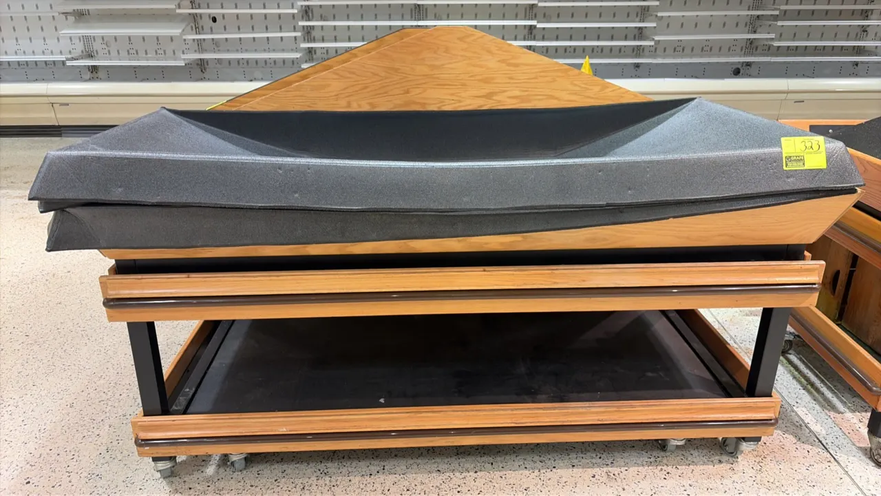 Produce display tables. Features woodgrain finish, black metal frame, lower storage shelf, and protective bumper guards. 6'L. Mounted on casters. Cont