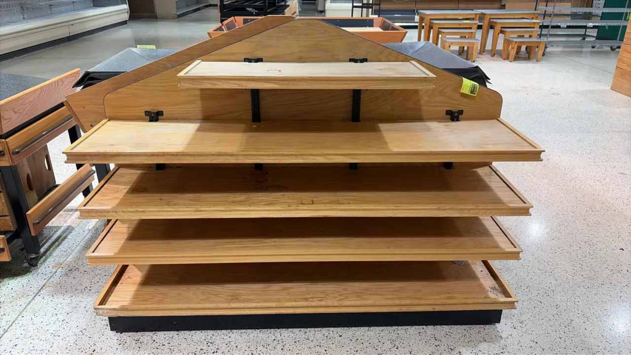 Wood produce end cap display shelving unit. Features five tiered wood shelves with edge retaining trim, adjustable metal brackets, and a peaked wooden