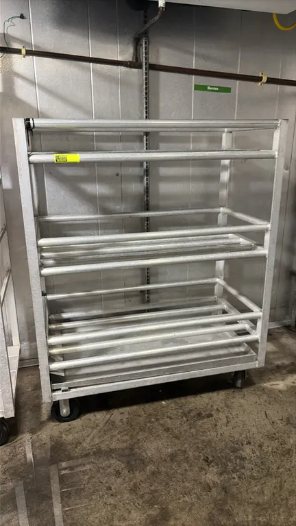 Galvanized 3-tier cart. Features tubular slatted shelving. 4'L. Mounted on casters.