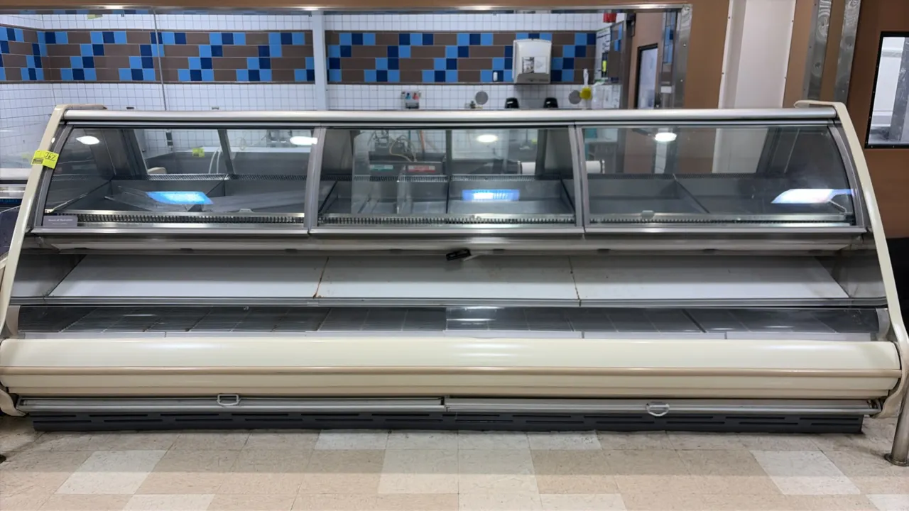 2007 Hill Phoenix PDNUM12 refrigerated service display case. Features upper curved glass front service section, lower refrigerated self-serve front de
