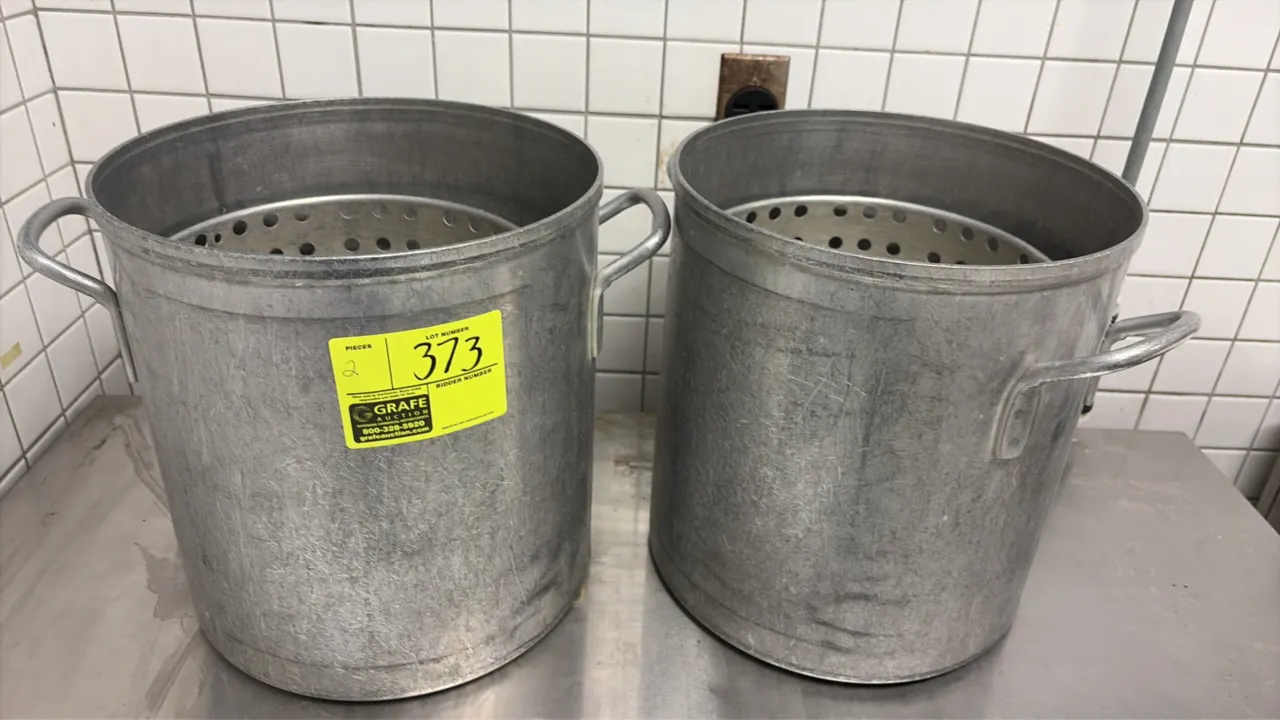 Aluminum seafood kettles. Features aluminum construction, dual side handles, and perforated strainer basket inserts.