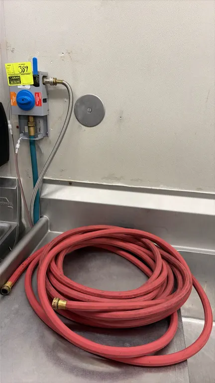 Chemstar chemical dispenser. Features push-button chemical proportioning for detergent and sanitizer, rotary valve assembly, braided supply line, blue