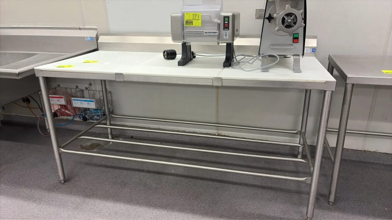 Stainless steel poly top work table. Features removable white poly cutting board top surface and stainless steel tubular undershelf. 72" x 30". Mounte