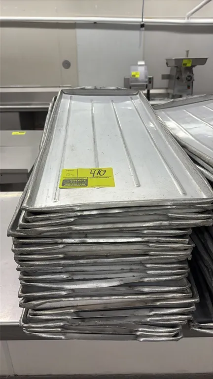 Aluminum meat platters. Features ribbed design and integrated end handles. Stackable. Dimensions: 30" x 12".