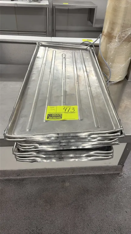 Stainless steel meat platters. Features ribbed bottoms and rolled edges. 30"L x 12"W.