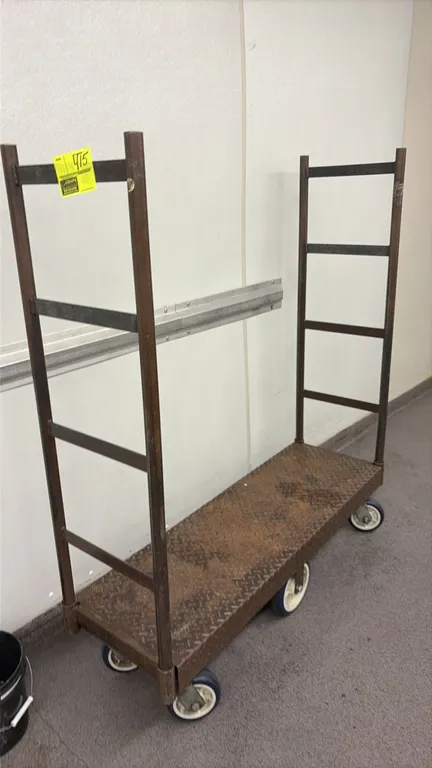 Metal 6-wheel U-boat platform cart. Features diamond tread plate deck and dual tall tubular end handles. Mounted on a 6-wheel center-tilt caster base.