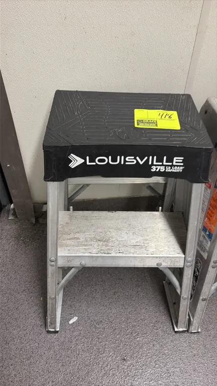 Louisville aluminum step ladder. Features molded top platform and ribbed slip-resistant step. 375 lb load capacity. Background items not included.