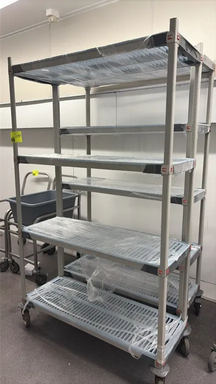 Metro MetroMax mobile shelving carts. Features (1) 4-tier cart and (1) 5-tier cart with removable slotted polymer shelf mats. 4'L. Mounted on swivel c
