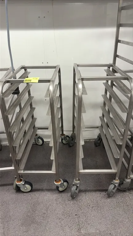 Stainless steel half-size pan racks. Features 6-tier angle slides and all-welded stainless steel construction. Mounted on swivel casters.