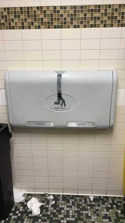 Diaper-Depot wall-mounted diaper changing stations. Features horizontal fold-down plastic construction with safety straps.
