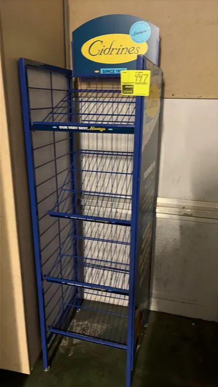 Cidrines branded wire merchandising display rack. Features blue powder-coated metal frame construction, multiple wire display shelves, branded graphic