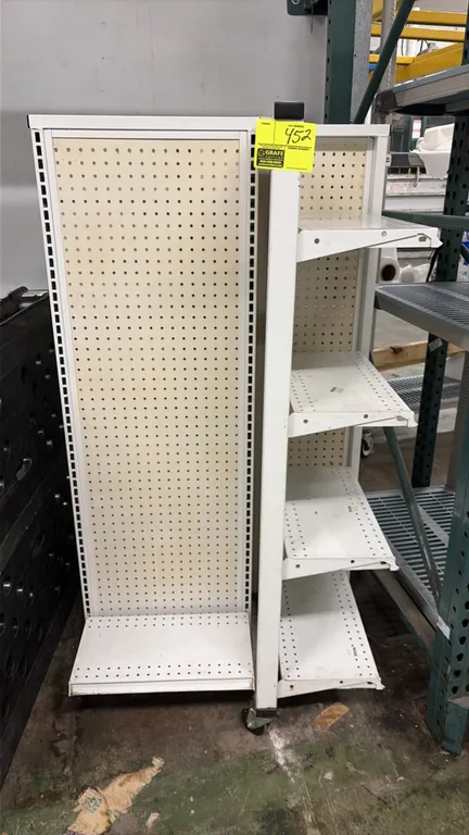4-way portable gondola display. Features pegboard backing and adjustable metal shelves. Mounted on casters.