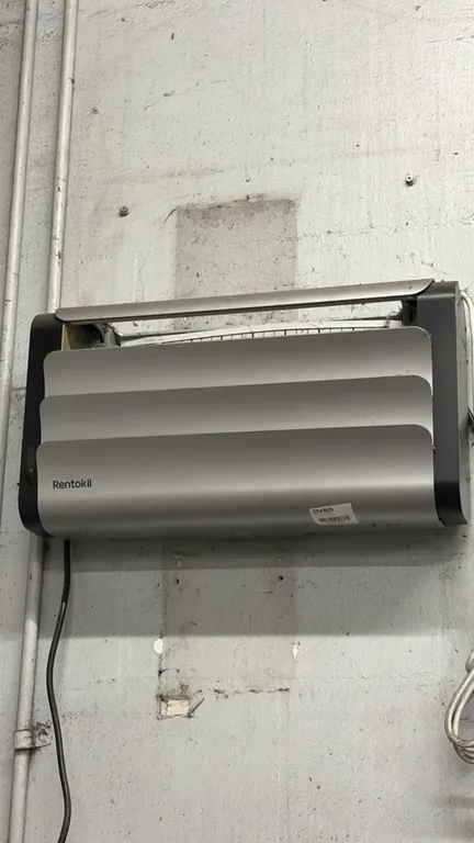 Rentokil insect light trap. Features a louvered silver-tone front panel. Wall mounted. Includes attached power cord.