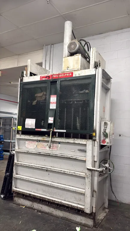 1997 PTR 2300HDLH 60" vertical cardboard baler. Features left-swing chamber door with hand wheel latch, upper wire mesh gate, and control box with key