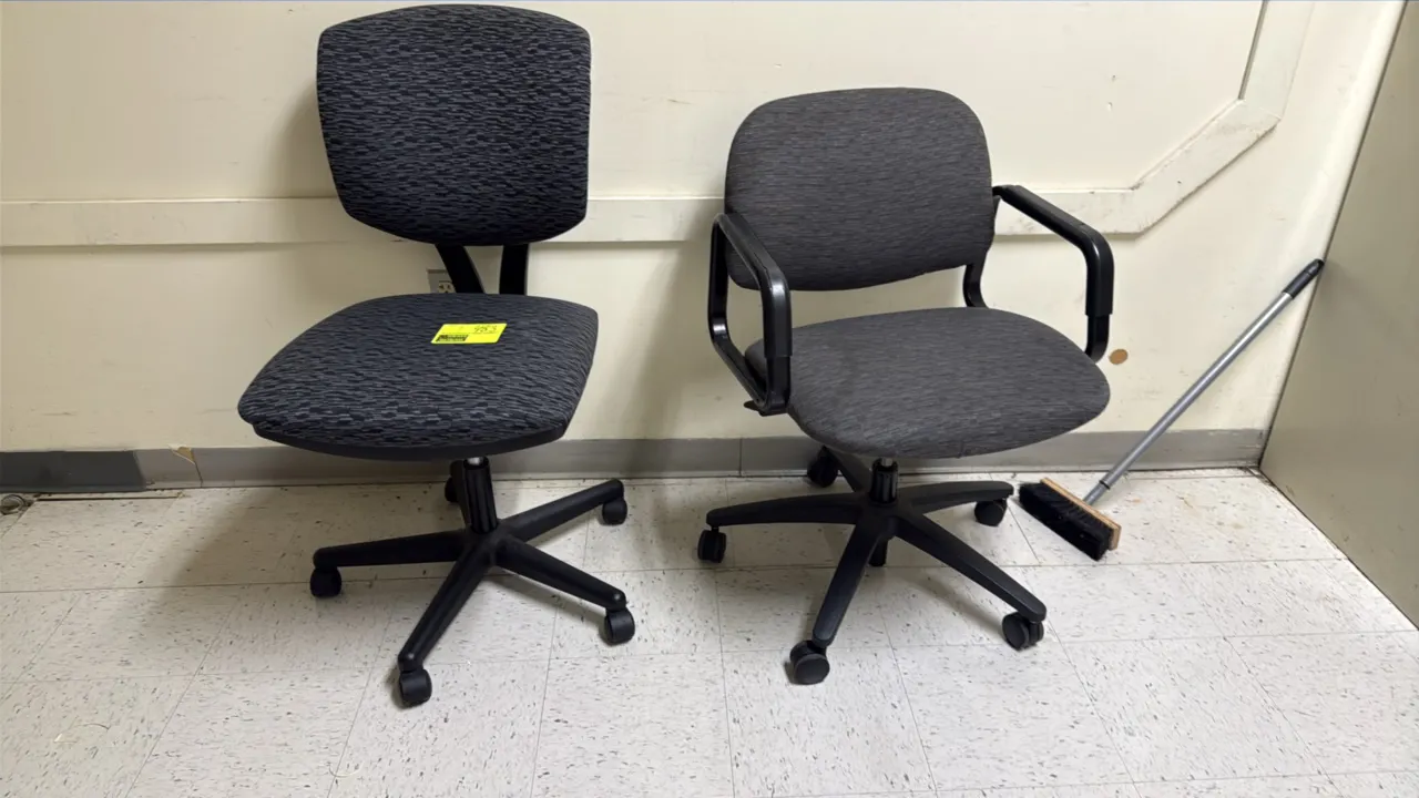 Rolling office chairs. Includes (1) armless task chair with patterned gray fabric upholstery and (1) armchair with fixed arms and gray fabric upholste