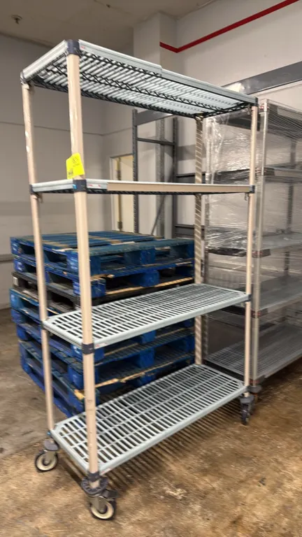 Metro MetroMax mobile shelving racks. Features 4 tiers of open grid shelves and composite posts. 48" x 18" x 80". Mounted on swivel casters with donut