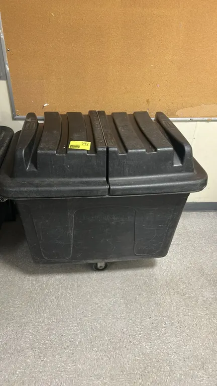 Rubbermaid poly trash cart. Features black polyethylene construction and a split hinged domed lid. Mounted on casters.