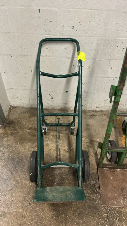Harper Series 700 welding cylinder cart. Features green tubular steel construction, curved cylinder cradles, solid toe plate, and rear kick-out suppor