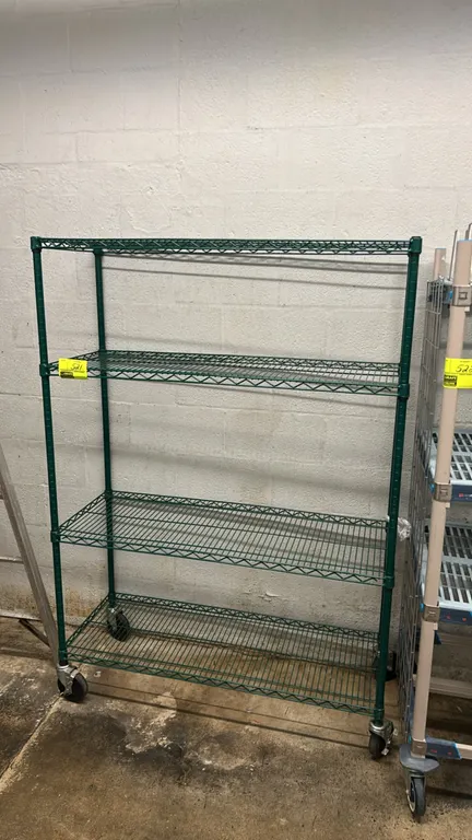 Metal wire 4-tier mobile shelving rack. Features green epoxy-coated finish and (4) wire shelves. 48" x 18". Mounted on casters.
