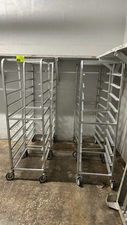 Aluminum full-size front-load channel racks. Features aluminum construction with angle channel pan slides. Mounted on swivel casters.