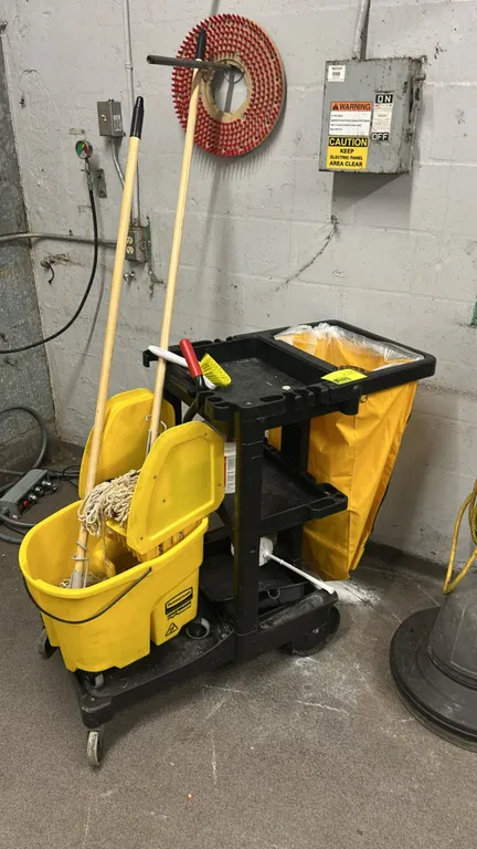 Rubbermaid poly multi-tier janitorial cleaning cart. Features 3-tier storage shelving, zippered yellow vinyl collection bag, and tool holders. Include