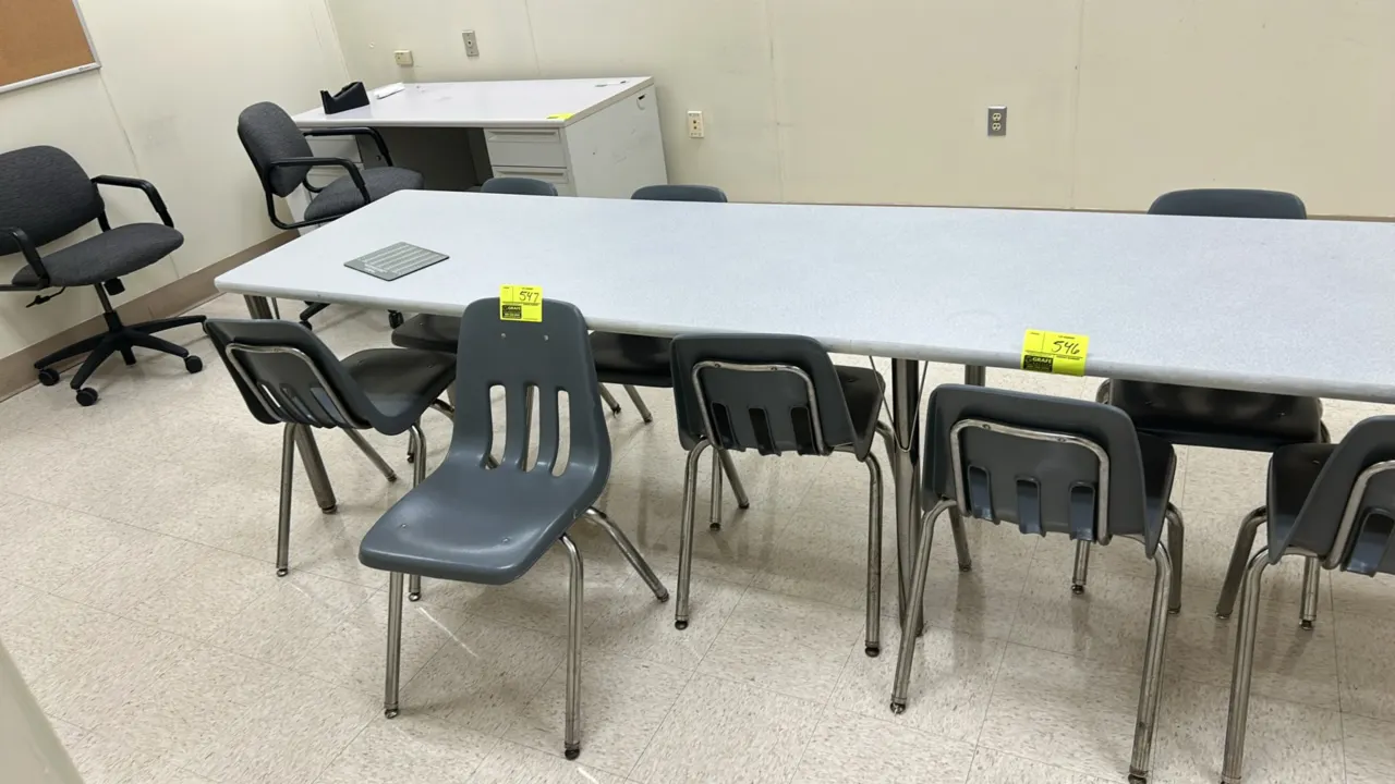Poly stacking chairs. Features gray molded polypropylene shells with vented backs. Mounted on tubular metal 4-leg bases with glides. Table and backgro