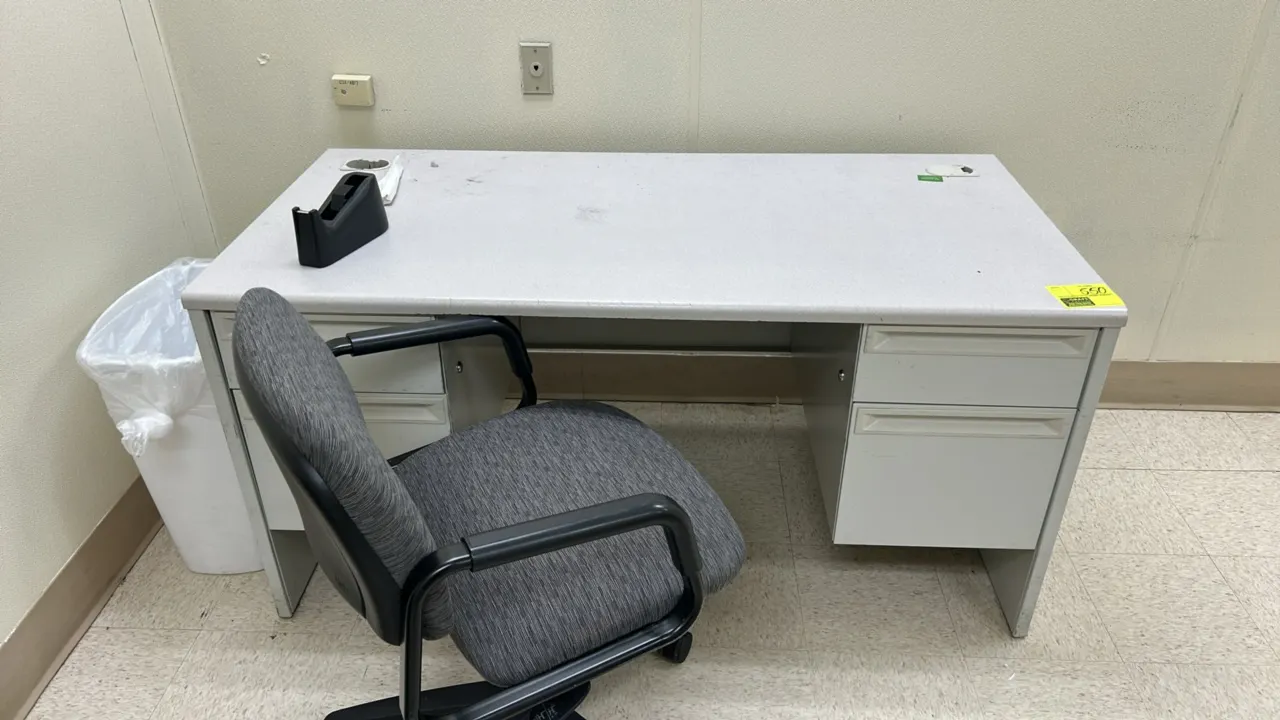 Laminate office desk with (2) rolling office chairs. Desk features a laminate top, dual pedestals with storage drawers, and cable pass-through grommet