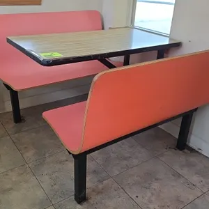 Plymold Contour 4-passenger restaurant booth dining set. Features pink molded contour bench seating and a woodgrain laminate tabletop with black edge 