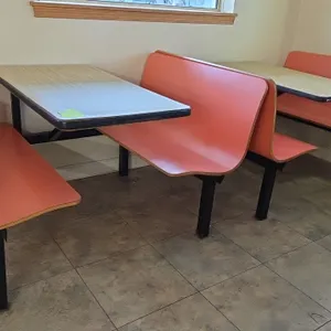 Plymold 4-passenger restaurant booth dining sets. Each set includes contoured bench seating and a woodgrain laminate tabletop. Mounted on a black meta