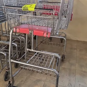 Unarco over-the-counter wire shopping carts. Features wire construction, upper basket with red plastic child seat, lower package platform, red corner 