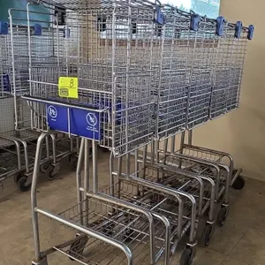 Over-the-counter wire shopping carts. Features upper wire basket, child seat with blue plastic flap, lower wire parcel tray, blue protective corner bu