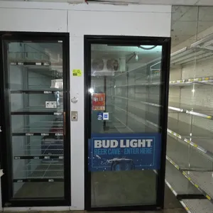 Walk-in insulated cooler. Features a 35" x 79" glass entry door, 29" x 77" reach-in glass door with feed racks, interior wall shelving, Heatcraft LSC1