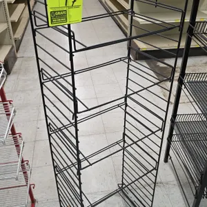 Metal merchandiser display rack. Features black wire construction with multi-tier adjustable shelf positions and a freestanding base. Dimensions: 17"W