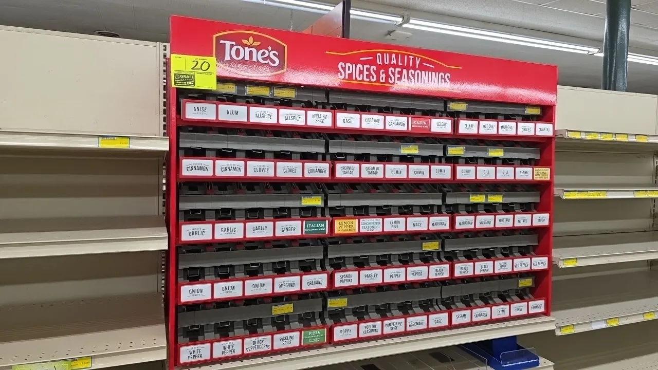 Tone's metal spices and seasoning display rack. Features 5 tiered rows with product organizer channels, individual spice labels, and branded red top m