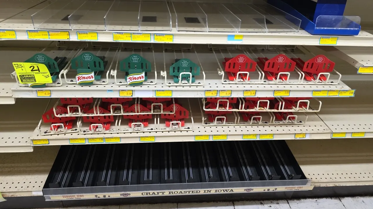Assorted product pushers and shelf dividers. Features spring-loaded wire rack pushers with green and red paddles, clear acrylic shelf dividers, and a