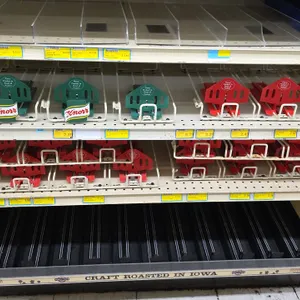 Assorted product pushers and shelf dividers. Features spring-loaded wire rack pushers with green and red paddles, clear acrylic shelf dividers, and a 