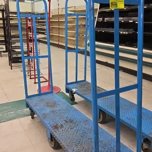 Metal 6-wheel U-boat platform cart. Features a blue diamond plate deck and tall tubular steel end handles. 60"L. Mounted on (6) wheels with rigid cent