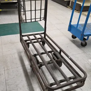 Tubular steel stock cart. Features an upright handle with an upper wire basket and tubular slatted platform deck. 39"L. Mounted on a 6-wheel configura