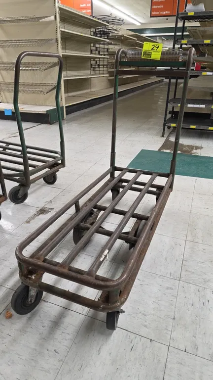 Tubular steel stock cart. Features a single push handle with an upper wire basket. 39"L. Mounted on 6 wheels with center-tilt rigid wheels and swivel