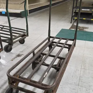 Tubular steel stock cart. Features a single push handle with an upper wire basket. 39"L. Mounted on 6 wheels with center-tilt rigid wheels and swivel 