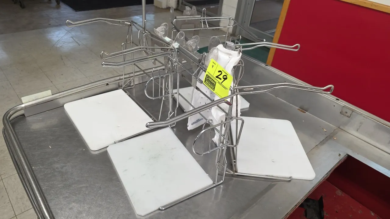 Metal grocery bag stands. Features wire frame construction, dual extended bag arms, and white polyethylene base boards. Bags and checkout counter not