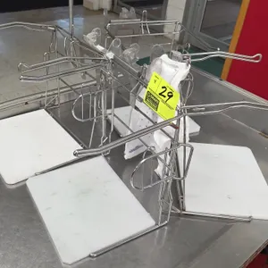 Metal grocery bag stands. Features wire frame construction, dual extended bag arms, and white polyethylene base boards. Bags and checkout counter not 