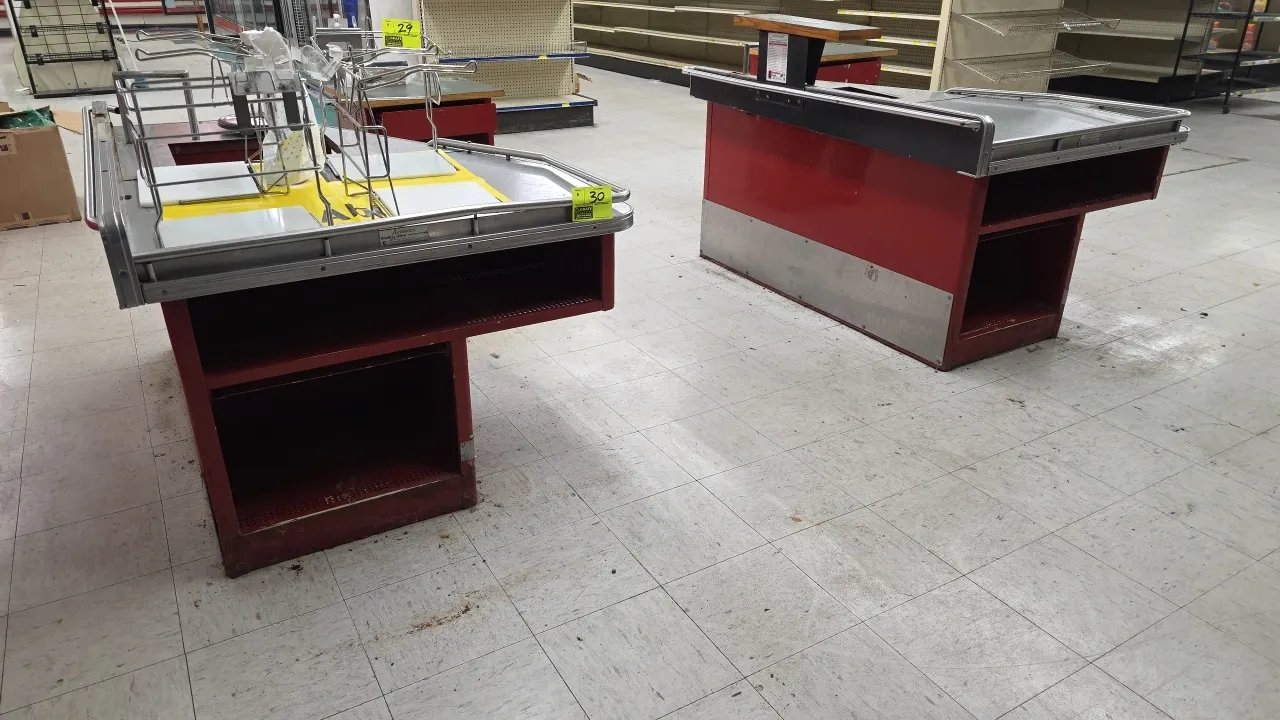Airway Critical Path metal checkout stations. Features stainless steel tops with bumper trim, scanner and scale cutouts, bag holder racks, lower stora