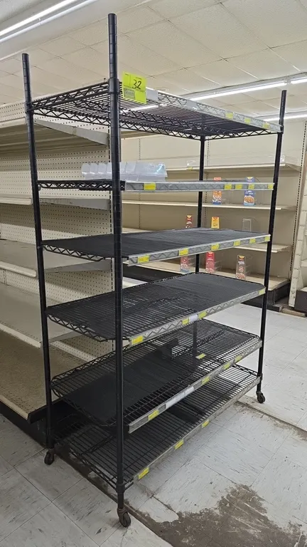 Portable 6-tier wire shelving unit. Features black wire construction, 6 adjustable shelves with shelf label channels, and shelf liners. 48"L x 21"W x